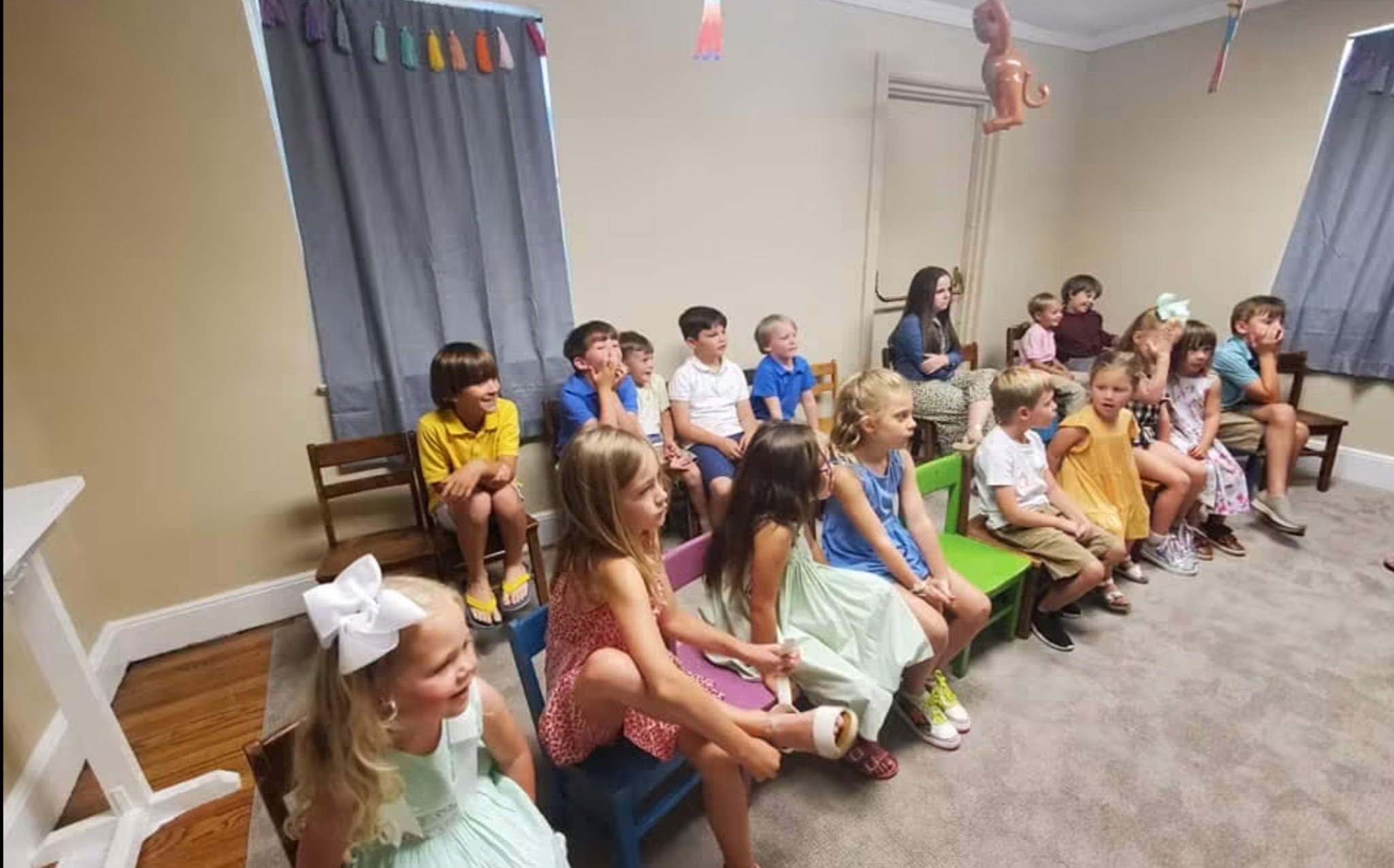 Children seated and engaged during the Bible story lesson